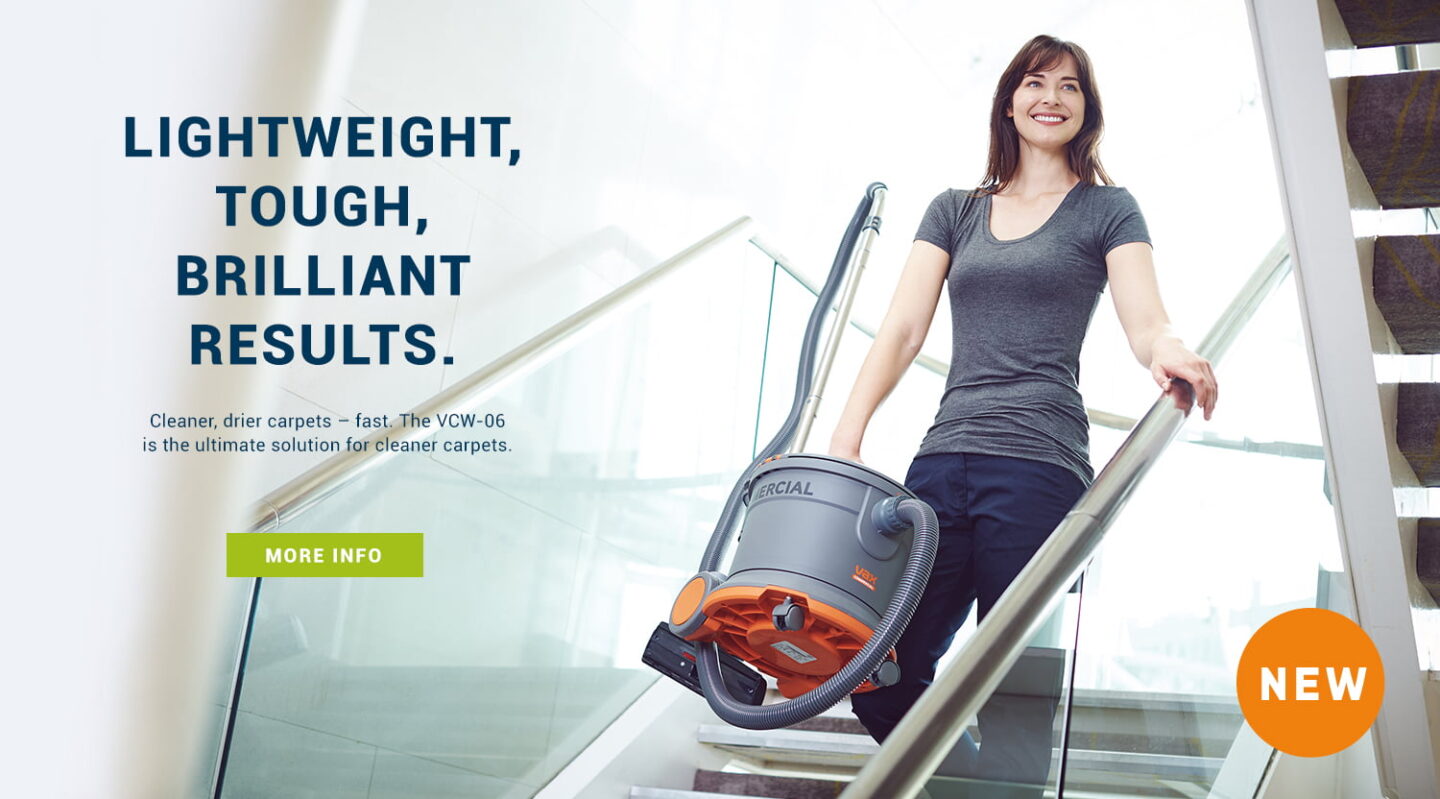 Vax commercial vacuum cleaner being carried down stairs