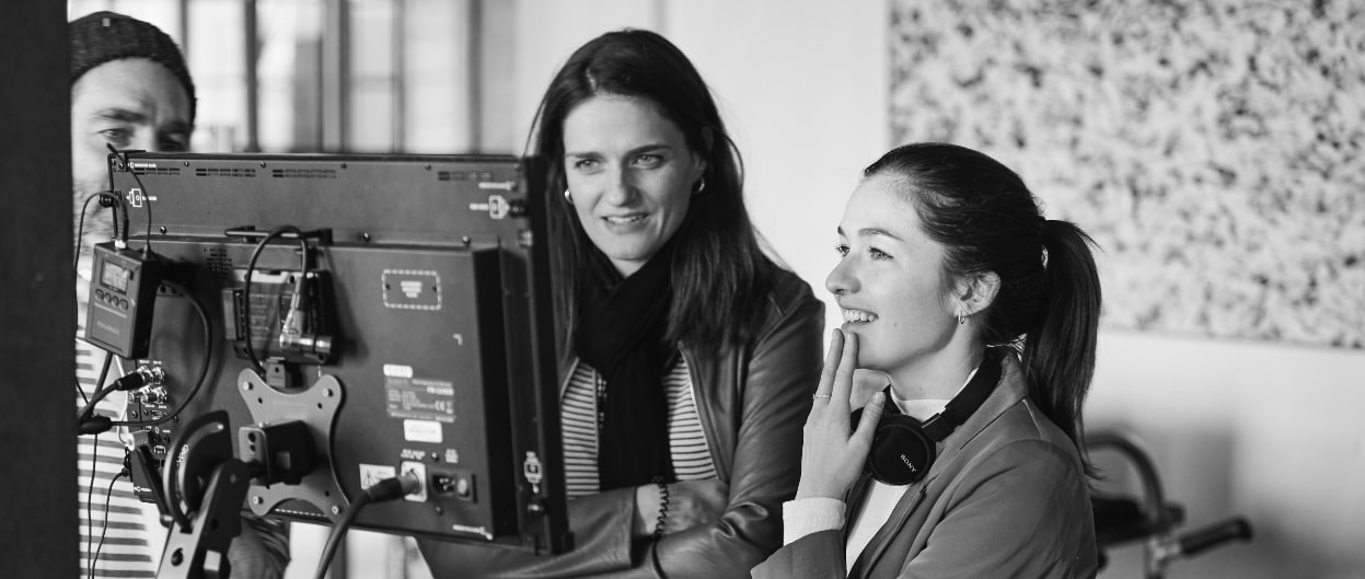 Client and video producer on a video set looking at monitor