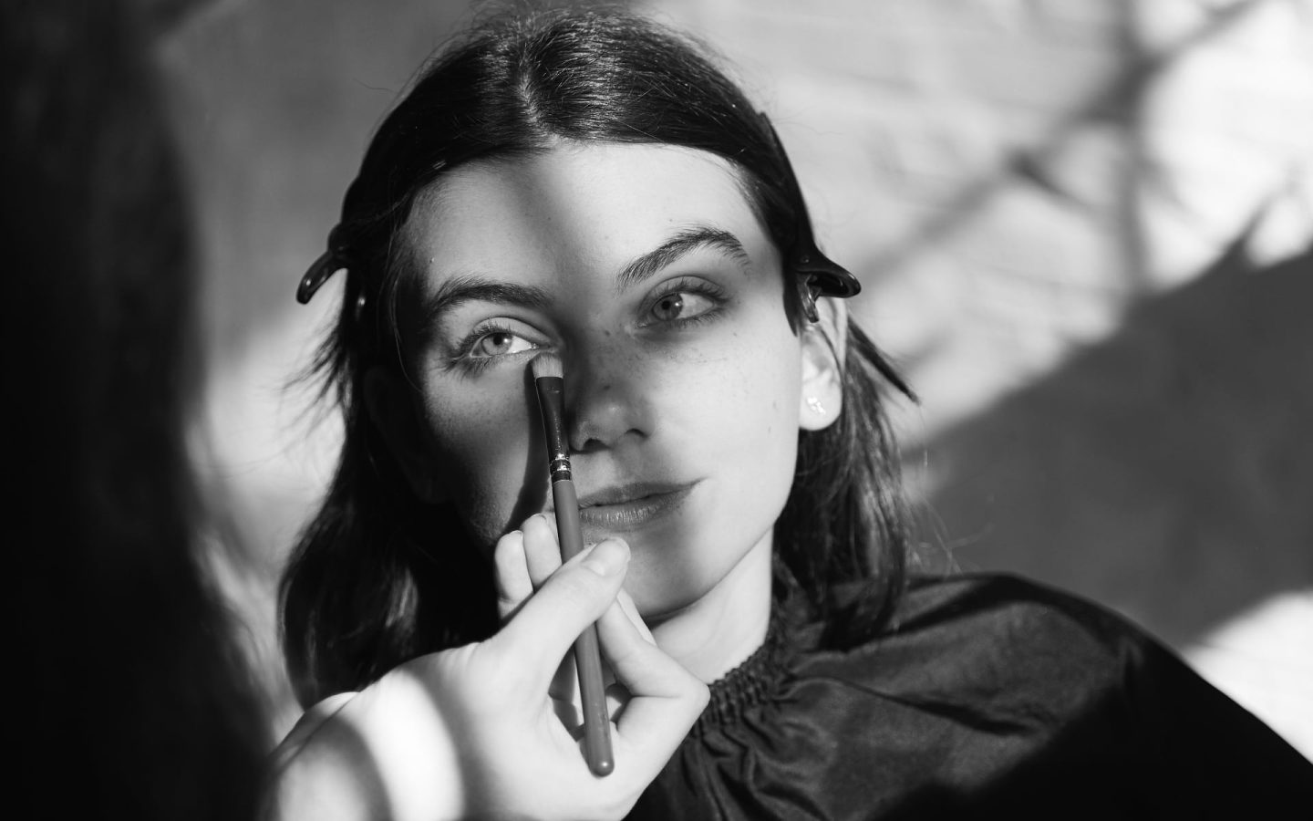 Girl having makeup applied at a testimonial video shoot